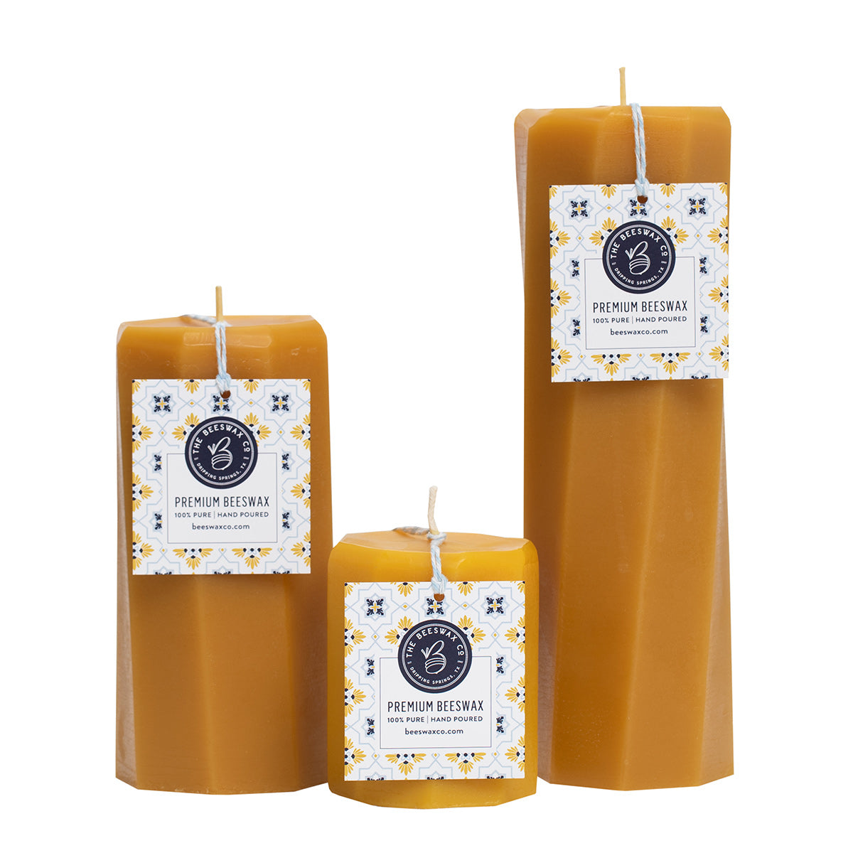 Three beeswax spiral octagon candles with labels on a white background